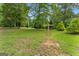 Expansive backyard showcasing a professional disc golf basket amidst a lush green landscape, perfect for outdoor recreation at 1572 Azalea Dr, Lawrenceville, GA 30043