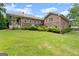 Large backyard with patio, brick house, and well-maintained green lawn at 1572 Azalea Dr, Lawrenceville, GA 30043