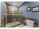 Bathroom featuring an elegant tiled shower with glass door, tiled floor, and modern fixtures at 1572 Azalea Dr, Lawrenceville, GA 30043