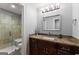 Bathroom featuring tile shower, granite vanity, and modern fixtures at 1572 Azalea Dr, Lawrenceville, GA 30043