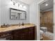 Bathroom featuring tile shower, granite vanity, and modern lighting at 1572 Azalea Dr, Lawrenceville, GA 30043