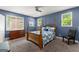 Comfortable bedroom with a four poster bed, ample natural light, and neutral colored carpet flooring at 1572 Azalea Dr, Lawrenceville, GA 30043
