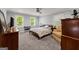 Bedroom with plush carpet, neutral walls, and plenty of natural light at 1572 Azalea Dr, Lawrenceville, GA 30043