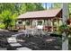 Inviting covered patio with seating, a swing, and views of the surrounding greenery and garden at 1572 Azalea Dr, Lawrenceville, GA 30043