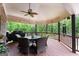 Spacious covered deck with beautiful outdoor seating, fan, and wooded views at 1572 Azalea Dr, Lawrenceville, GA 30043
