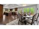 Dining area with wood table, chandelier, and view of updated kitchen at 1572 Azalea Dr, Lawrenceville, GA 30043