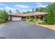 Charming brick home featuring a long driveway, well-manicured landscaping, covered porch, and attached two-car garage at 1572 Azalea Dr, Lawrenceville, GA 30043