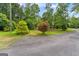 Lush front yard with mature trees, offering privacy and curb appeal to this beautiful property at 1572 Azalea Dr, Lawrenceville, GA 30043