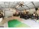 Spacious garage workshop featuring a four-wheeler, tool storage and a roll-up door at 1572 Azalea Dr, Lawrenceville, GA 30043