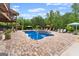 Beautiful in-ground pool and spa surrounded by mature landscaping and outdoor lounge seating at 1572 Azalea Dr, Lawrenceville, GA 30043