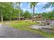 Spacious backyard features mature trees, landscaping, an outdoor kitchen, garden area, and other outdoor recreational facilities at 1572 Azalea Dr, Lawrenceville, GA 30043