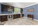 Kitchen featuring stainless steel appliances, dark wood cabinets, and a window at 1572 Azalea Dr, Lawrenceville, GA 30043