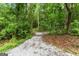 Gravel pathway in a lush green area, showcasing the property's natural landscape and walking trails at 1572 Azalea Dr, Lawrenceville, GA 30043