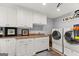 Laundry room with white cabinets, granite countertop, laundry sink, washer and dryer at 1572 Azalea Dr, Lawrenceville, GA 30043