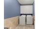 Laundry room features a washer and dryer set with a cabinet above them for storage at 1572 Azalea Dr, Lawrenceville, GA 30043