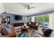 Open living room with sofas, and view of the outdoor pool and patio at 1572 Azalea Dr, Lawrenceville, GA 30043