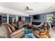 Living room featuring ceiling fan, tv, sofas, and tile flooring at 1572 Azalea Dr, Lawrenceville, GA 30043