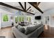 Bright living room with exposed beams, hardwood floors, and large windows at 1572 Azalea Dr, Lawrenceville, GA 30043