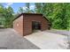 Metal outbuilding or shop with concrete driveway and partial roll up door at 1572 Azalea Dr, Lawrenceville, GA 30043