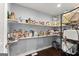 Walk-in pantry featuring shelves full of food items and a vinyl floor at 1572 Azalea Dr, Lawrenceville, GA 30043