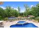Backyard pool area features a relaxing pool, lounge seating, and beautiful views of the surrounding landscape at 1572 Azalea Dr, Lawrenceville, GA 30043