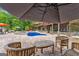 Backyard oasis with a sparkling pool, brick patio, and a multi-level brick home, creating an inviting outdoor living space at 1572 Azalea Dr, Lawrenceville, GA 30043