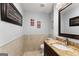 Charming powder room features elegant granite countertop and framed mirror at 1572 Azalea Dr, Lawrenceville, GA 30043
