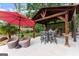 Covered patio featuring an outdoor kitchen with a granite countertop island, stone backsplash, and stainless steel appliances at 1572 Azalea Dr, Lawrenceville, GA 30043
