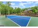 Backyard tennis court and serene pavilion in the background of this estate at 1572 Azalea Dr, Lawrenceville, GA 30043