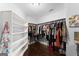 Organized walk-in closet with shelving and ample hanging space for clothing at 1572 Azalea Dr, Lawrenceville, GA 30043