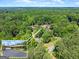 Aerial view of estate with private entrance, circular driveway, porte cochere, mature trees, and professional landscaping at 1572 Azalea Dr, Lawrenceville, GA 30043
