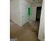 Hallway with white walls, beige carpet, and visible doorways, offering a glimpse into the home's interior at 220 Peach Forest Pl, Douglasville, GA 30134