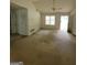 Spacious living room featuring high ceilings, large windows, a ceiling fan, and natural light throughout at 220 Peach Forest Pl, Douglasville, GA 30134