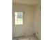 Utility room featuring a back door with window panes that allows a view of the exterior yard space at 220 Peach Forest Pl, Douglasville, GA 30134