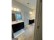 Bathroom featuring dual vanities, tile floors, and separate rooms for shower and toilet at 2208 Ginger Lake Ne Dr, Conyers, GA 30013