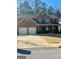 Traditional brick home with attached two car garage, covered porch, and well maintained lawn at 2208 Ginger Lake Ne Dr, Conyers, GA 30013
