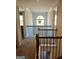 Second story hallway featuring hardwood banister and large window with arched top at 2208 Ginger Lake Ne Dr, Conyers, GA 30013