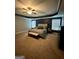 Primary bedroom with a tray ceiling, carpet, and two large windows at 2208 Ginger Lake Ne Dr, Conyers, GA 30013