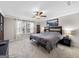 Spacious bedroom featuring neutral walls, ceiling fan, patterned headboard, and plush carpeting at 4065 Holland Grove, Lawrenceville, GA 30044