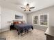 Comfortable bedroom with large window, carpet flooring and neutral paint at 4065 Holland Grove, Lawrenceville, GA 30044