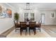 Well-lit dining room with seating for six, stylish light fixture, and a large window at 4065 Holland Grove, Lawrenceville, GA 30044