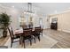 Dining room featuring a wooden table with seating for six, neutral walls, and modern lighting at 4065 Holland Grove, Lawrenceville, GA 30044