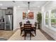 Dining area with wood table, seating for six, a tree, and lots of natural light at 4065 Holland Grove, Lawrenceville, GA 30044