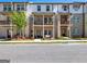 Modern brick townhome exterior with balconies, street view, and small front yard at 4065 Holland Grove, Lawrenceville, GA 30044