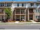 Charming two-story brick townhome with inviting balconies and well-manicured landscaping at 4065 Holland Grove, Lawrenceville, GA 30044