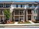 Beautiful brick townhome with a covered front porch, balcony, and well-maintained landscaping at 4065 Holland Grove, Lawrenceville, GA 30044