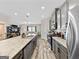 Modern kitchen boasts stainless steel appliances, gray cabinets, and granite countertops with an open layout at 4065 Holland Grove, Lawrenceville, GA 30044