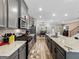 Stylish kitchen features stainless steel appliances, gray cabinets, granite countertops, and wood flooring at 4065 Holland Grove, Lawrenceville, GA 30044