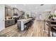 Bright kitchen with stainless steel appliances, gray cabinets, a kitchen island, and seating for four at 4065 Holland Grove, Lawrenceville, GA 30044