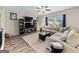 Cozy living room with a large sectional couch, decorative shelving, and a ceiling fan at 4065 Holland Grove, Lawrenceville, GA 30044